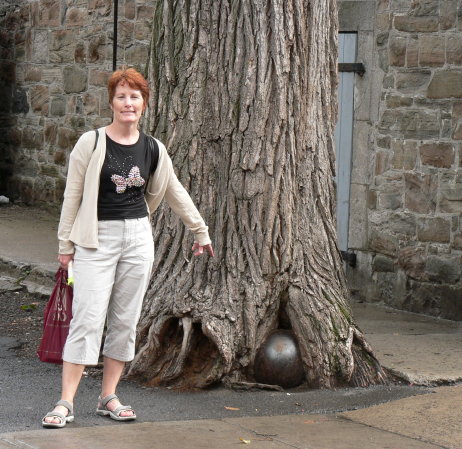 P1080790 Jane by tree with cannon ball in roots, upper town, Quebec